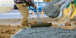A skilled concrete contractor meticulously crafting a concrete surface near me in Tampa.